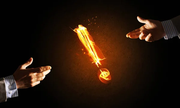 Hands with fire glowing exclamation mark — Stock Photo, Image