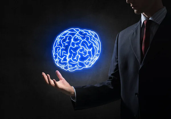 Businessman holding brain in palm — Stock Photo, Image