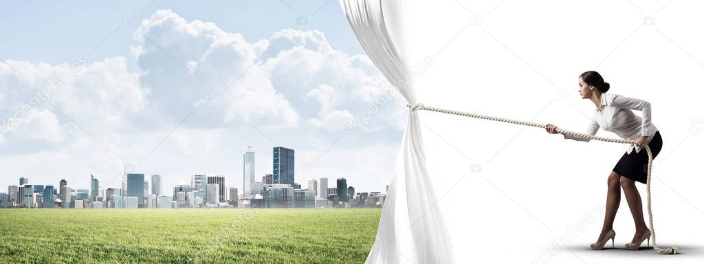 Young woman opening white curtain