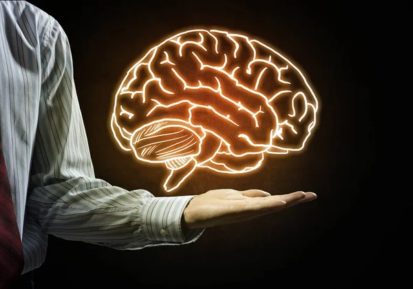 businessman holding brain in palm