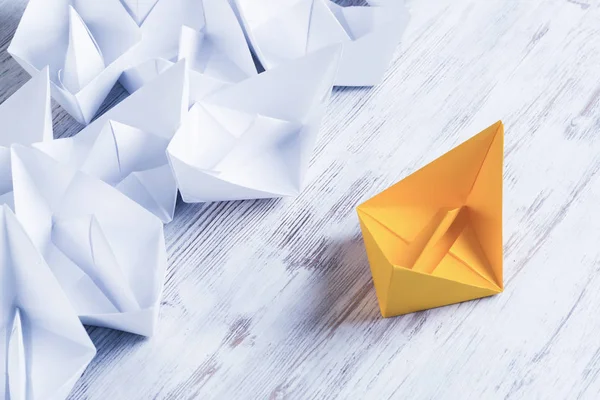 Set of origami boats on wooden table