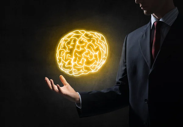 Businessman holding brain in palm — Stock Photo, Image