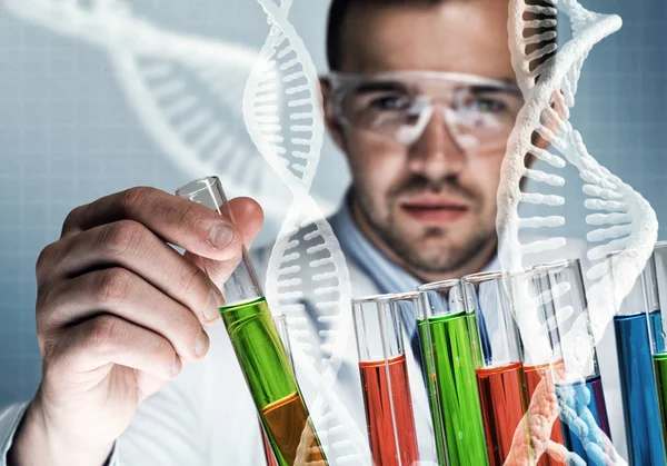 Young scientist mixing reagents — Stock Photo, Image