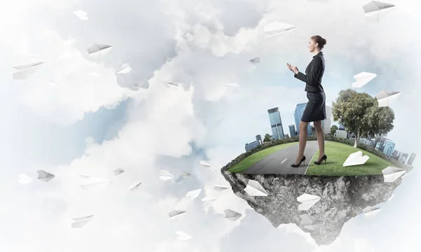 Businesswoman standing on green floating island — Stock Photo, Image
