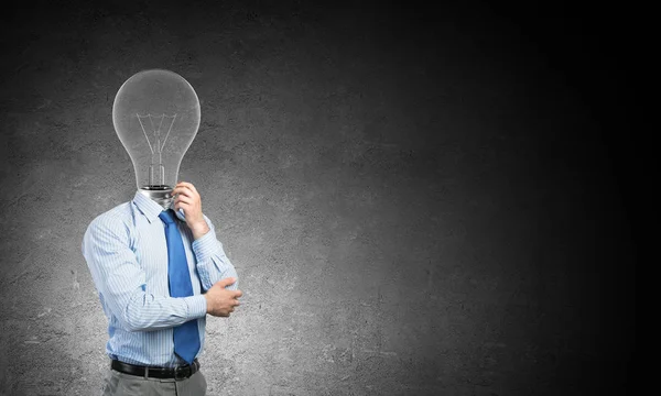 Pensive businessman with lamp head — Stock Photo, Image