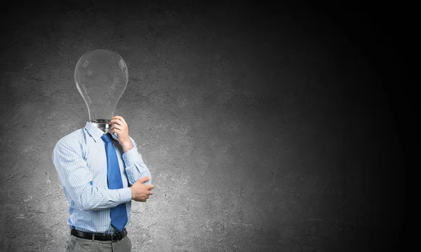 Pensive businessman with lamp head — Stock Photo, Image