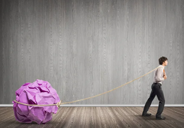 Man pulling with effort big ball — Stock Photo, Image