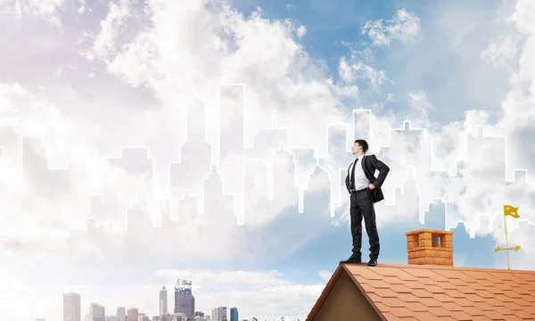 Uomo d'affari in piedi sul tetto della casa — Foto Stock