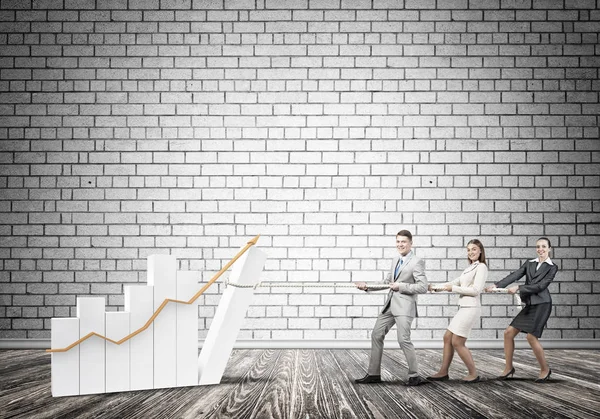 Business people pulling up graph — Stock Photo, Image