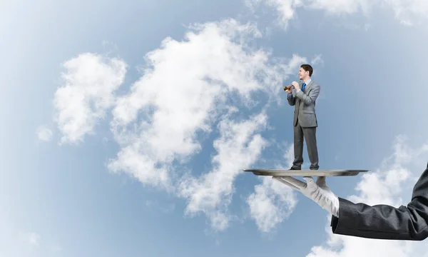 Young businessman on metal tray — Stock Photo, Image