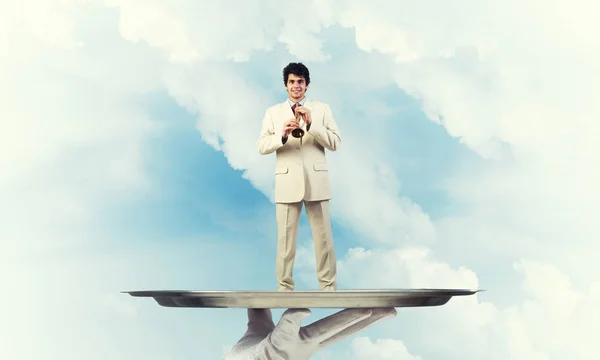 Young businessman on metal tray — Stock Photo, Image