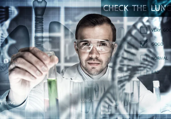 Scientist mixing reagents in glass flask — Stock Photo, Image