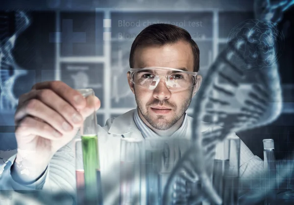 Young scientist mixing reagents — Stock Photo, Image