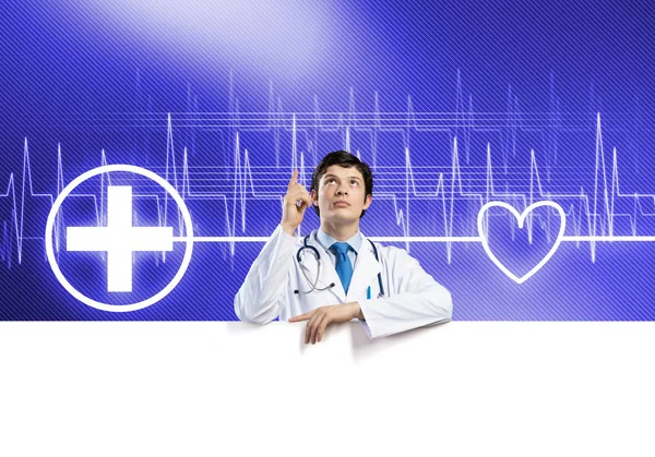 Doctor holding white blank banner — Stock Photo, Image