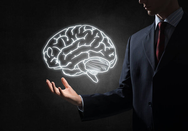 business man hand holding brain in palm
