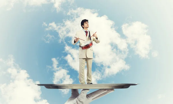 Young businessman on metal tray — Stock Photo, Image