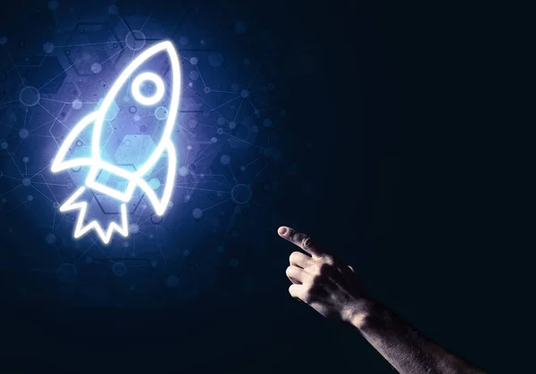 Rocket glowing icon and man hand — Stock Photo, Image