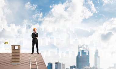 Engineer standing on roof clipart