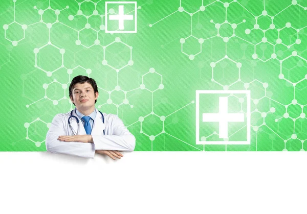 Doctor holding white blank banner — Stock Photo, Image