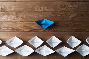 Beyaz ve renkli kağıt tekneler ahşap masa üzerinde
