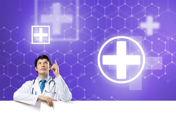 Doctor holding white blank banner — Stock Photo, Image