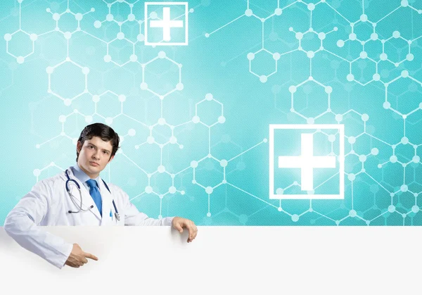 Doctor holding white blank banner — Stock Photo, Image