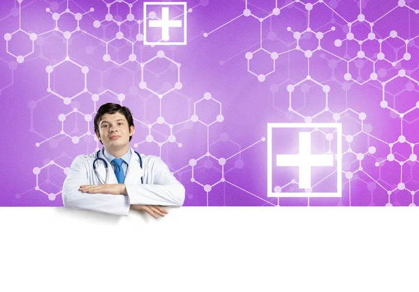 Doctor holding white blank banner — Stock Photo, Image
