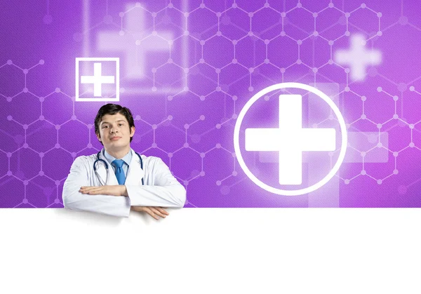 Doctor holding white blank banner — Stock Photo, Image