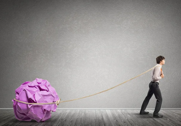 Man pulling with effort big ball — Stock Photo, Image