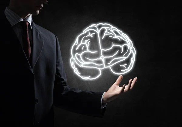 Business man hand holding brain sketch — стоковое фото