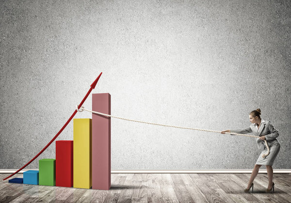 Young businesswoman growing graph