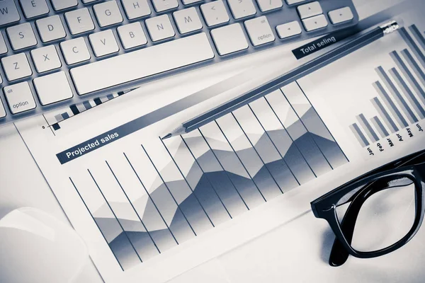 Business workplace with keyboard and glasses — Stock Photo, Image