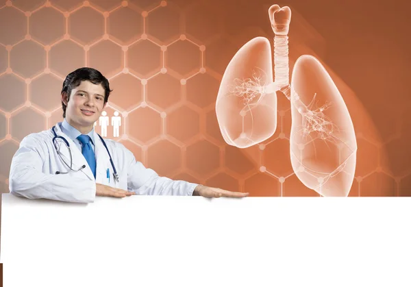 Doctor holding white blank banner — Stock Photo, Image