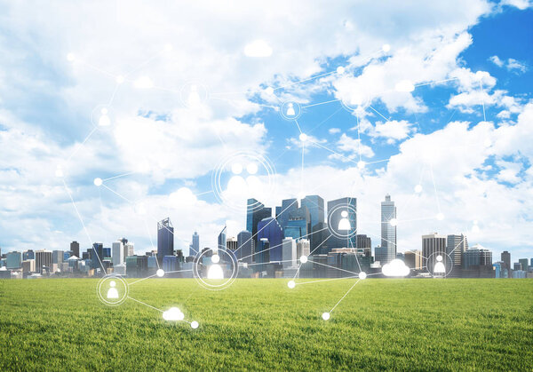 Modern cityscape with green grass and social connection concept on screen
