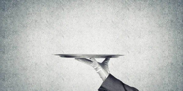 Waiter hand presenting empty tray — Stock Photo, Image