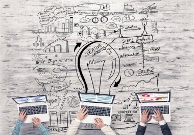 Bir grup ellerinde aygıtlarla üç insan