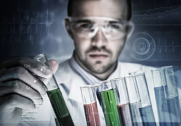 Young scientist mixing reagents Royalty Free Stock Photos