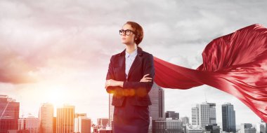 confident businesswoman wearing red cape clipart