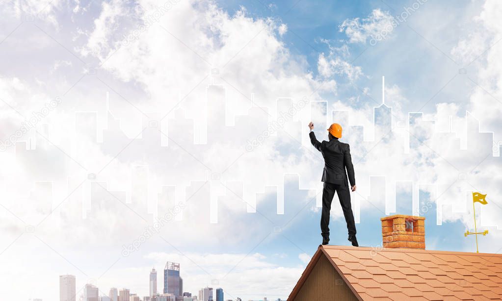 Engineer man standing on house roof 