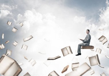 Genç işadamı mavi gökyüzünde yüzen 