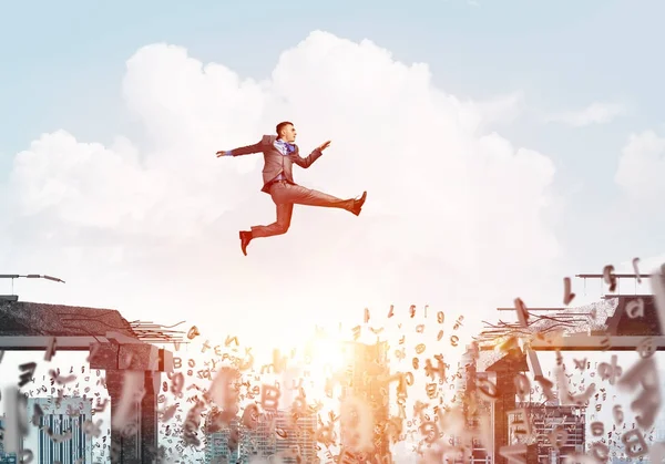 Businessman jumping over gap with flying letters in concrete bridge as symbol of overcoming challenges with cityscape on background, 3D rendering