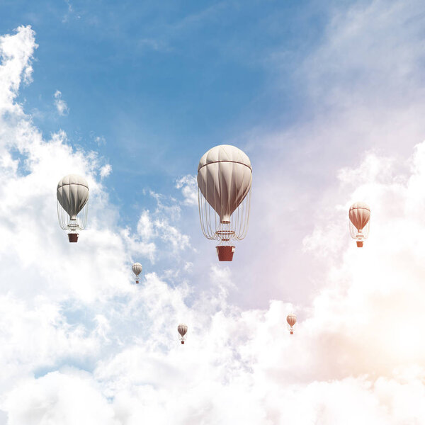 Colorful aerostats flying over the blue cloudy sky. 3D rendering.