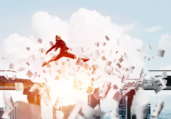 Businesswoman jumping over gap with flying paper documents in concrete bridge as symbol of overcoming challenges. Cloudly skyscape with sunlight on background. 3D rendering.