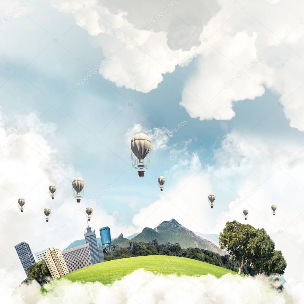 Green flying island with urban view of towers and skyscrapers. Flying aerostates and blue cloudy skyscape on background. 