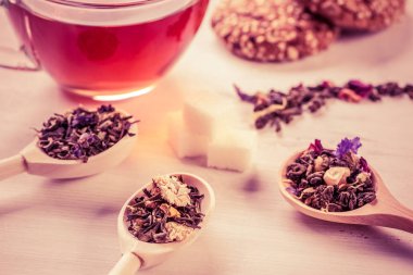 Bitkisel çay otları ve kurabiyeler masada.