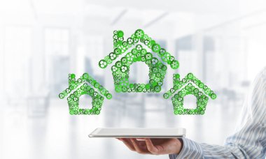 Tablet pc ev işaretleri ile bağlı Dişliler, karışık teknik yapılan tutan bir işadamı kapatmak