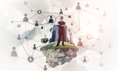 Modern kablosuz teknolojileri kavramı mavi gökyüzünde yüzen yeşil Adası üzerinde zarif işadamı