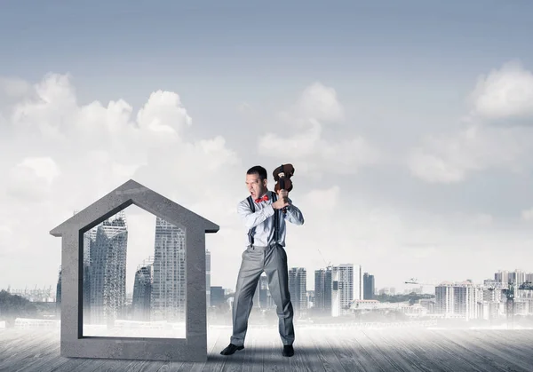 Determined businessman going to break with violin house concrete figure