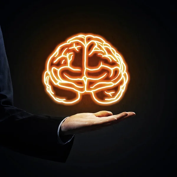 Business man hand holding brain in palm — стоковое фото