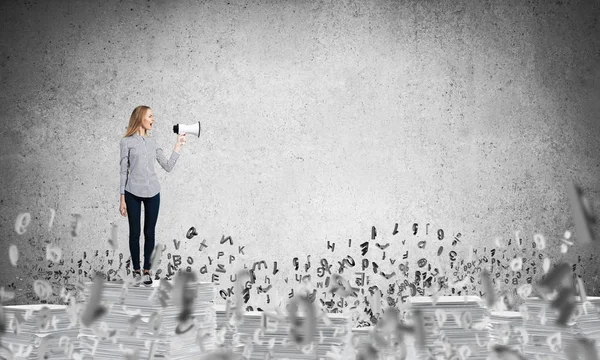 Woman Casual Clothing Standing Flying Letters Speaker Hand Grey Wall — Stock Photo, Image